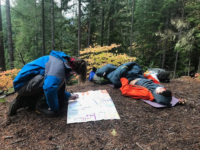 Students practicing Wilderness First Aid skills using the Slipstream Map for their WFA Responder certification.